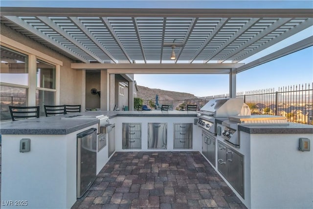 view of patio / terrace with a pergola, area for grilling, a mountain view, and grilling area