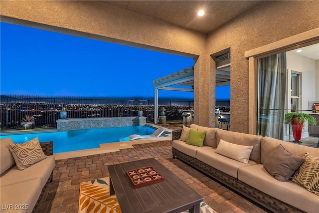 pool at dusk with outdoor lounge area and a patio area