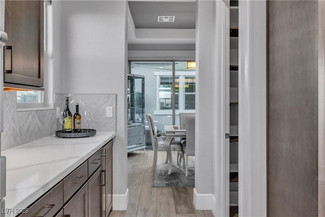 kitchen with tasteful backsplash and light stone counters