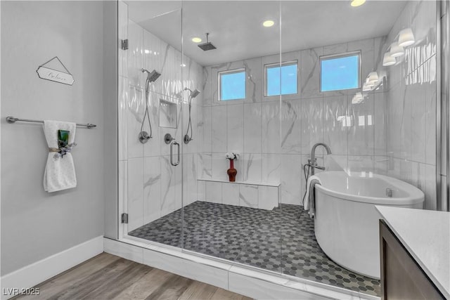 bathroom with separate shower and tub, hardwood / wood-style floors, and vanity