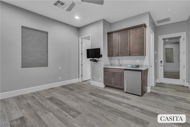 kitchen with light wood-type flooring, refrigerator, dark brown cabinetry, ceiling fan, and sink