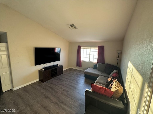 living room featuring dark hardwood / wood-style flooring and vaulted ceiling