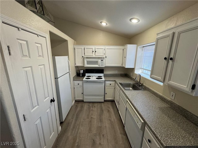 kitchen with white appliances, sink, white cabinets, dark hardwood / wood-style floors, and lofted ceiling