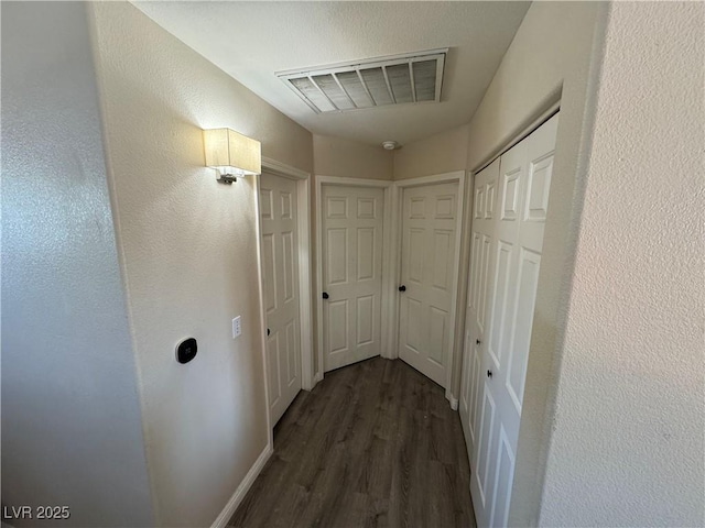 corridor featuring dark hardwood / wood-style floors