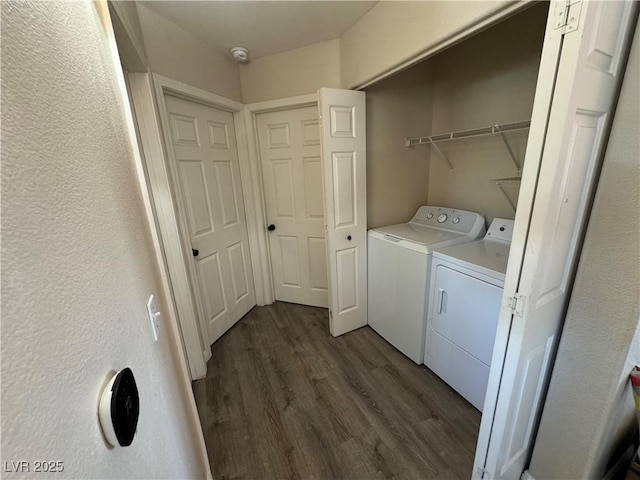 laundry area with independent washer and dryer and dark wood-type flooring