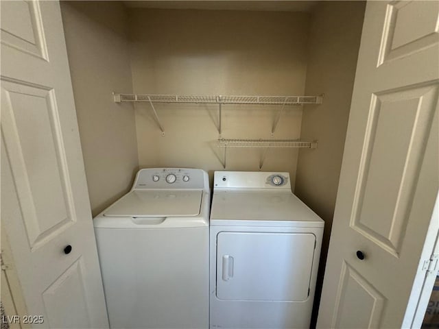 clothes washing area featuring separate washer and dryer