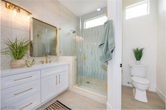 bathroom featuring tile patterned floors, vanity, toilet, and a shower with shower door