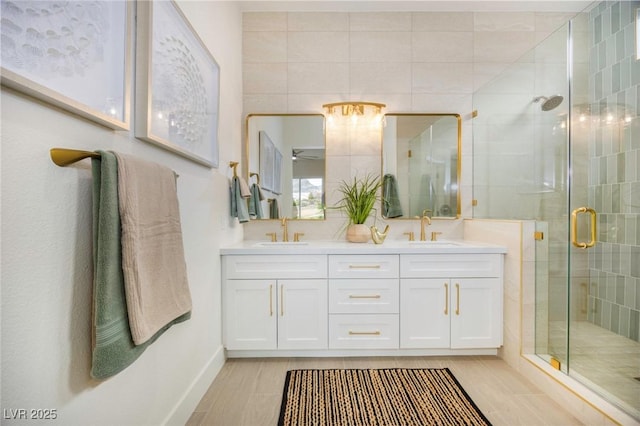 bathroom featuring vanity, walk in shower, and ceiling fan