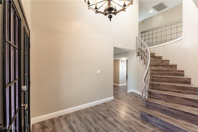 foyer with dark wood-type flooring and a chandelier