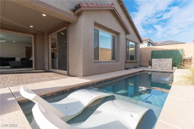 view of swimming pool with a water slide and a patio area