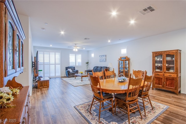 dining area with ceiling fan and light wood-type flooring