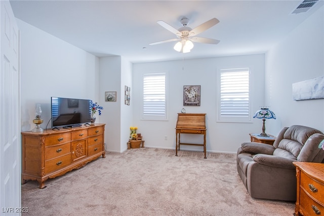 sitting room with light carpet, ceiling fan, and a healthy amount of sunlight