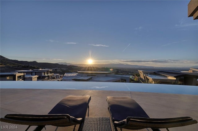 pool at dusk featuring a mountain view