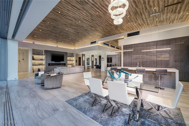 dining space with wooden ceiling, a high ceiling, and a notable chandelier