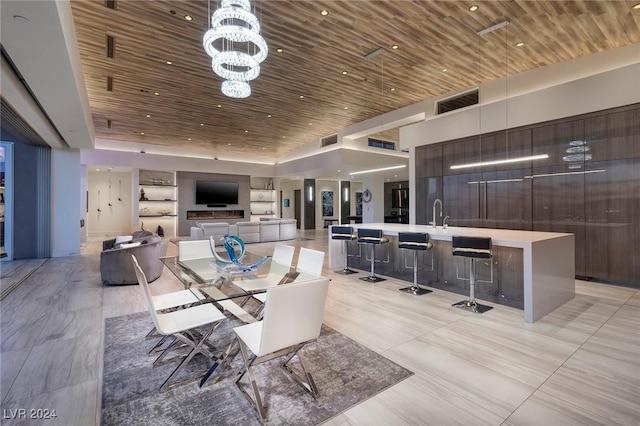 tiled dining area with a chandelier and wooden ceiling