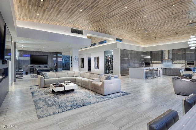 living room with wood ceiling and light tile patterned floors