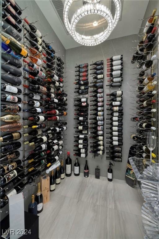 wine cellar with tile patterned flooring and a notable chandelier