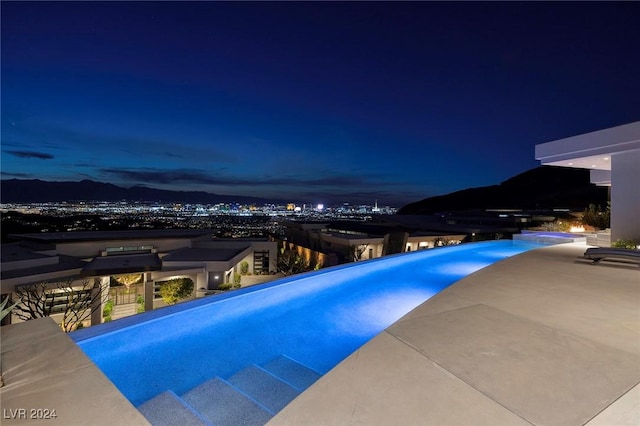 view of pool at twilight