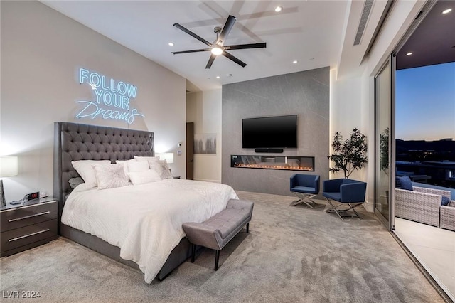 bedroom featuring ceiling fan, carpet floors, and a fireplace