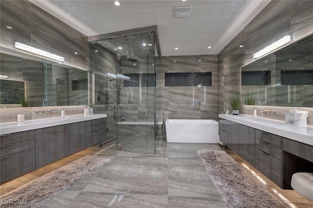 bathroom with vanity and separate shower and tub