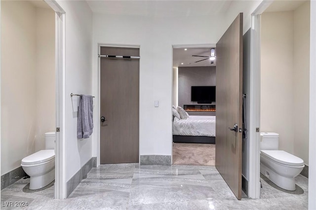 bathroom featuring toilet and ceiling fan