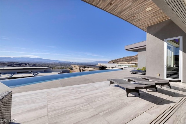 view of patio / terrace with a mountain view