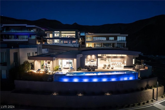 back house at night featuring a mountain view