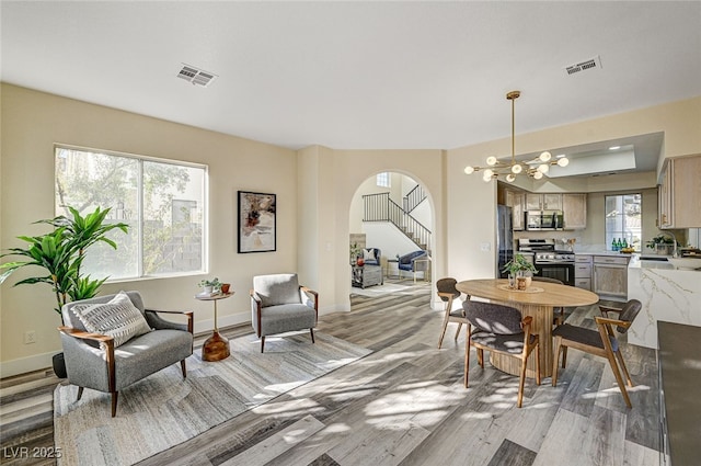 dining area featuring light hardwood / wood-style flooring and a chandelier