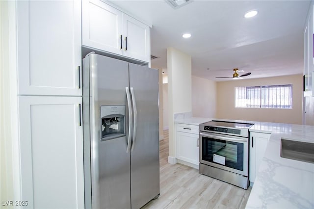 kitchen featuring light stone countertops, ceiling fan, stainless steel appliances, white cabinets, and light wood-type flooring