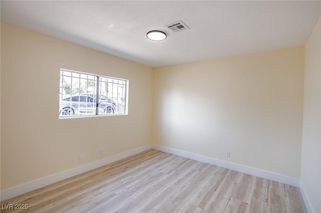 spare room with light hardwood / wood-style floors