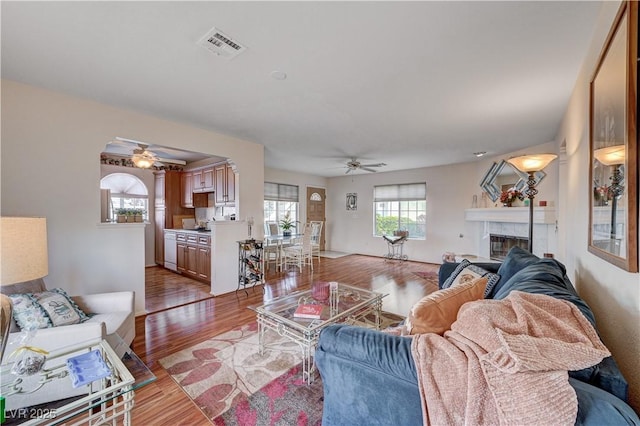 living room with light wood-type flooring and ceiling fan