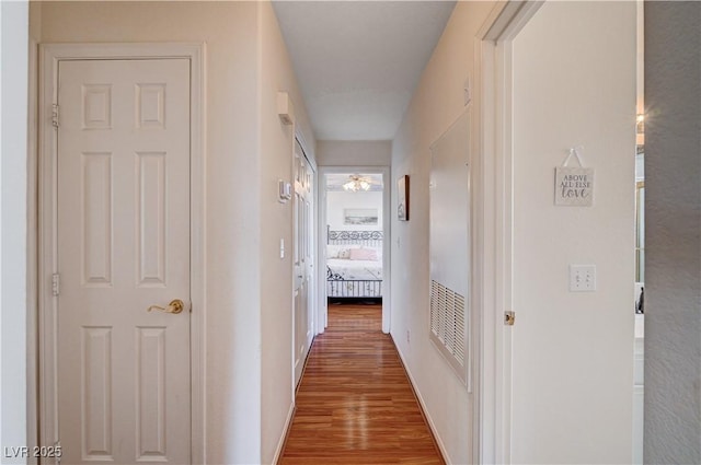 hallway with wood-type flooring