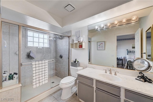 bathroom featuring tile patterned floors, vanity, a shower with shower door, and toilet