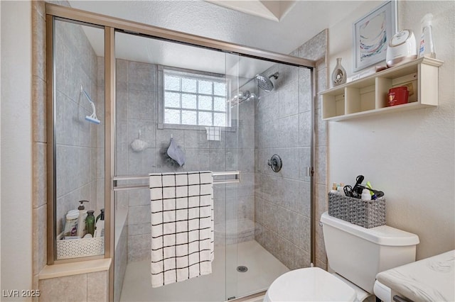 bathroom featuring toilet and an enclosed shower