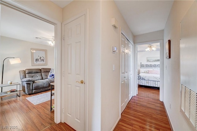 corridor with hardwood / wood-style floors