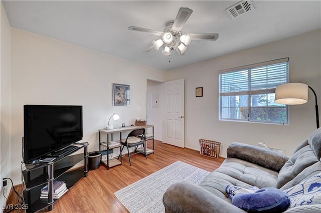 living room with ceiling fan and light hardwood / wood-style floors