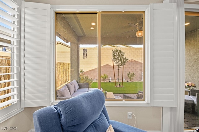 sunroom / solarium with a wealth of natural light and ceiling fan