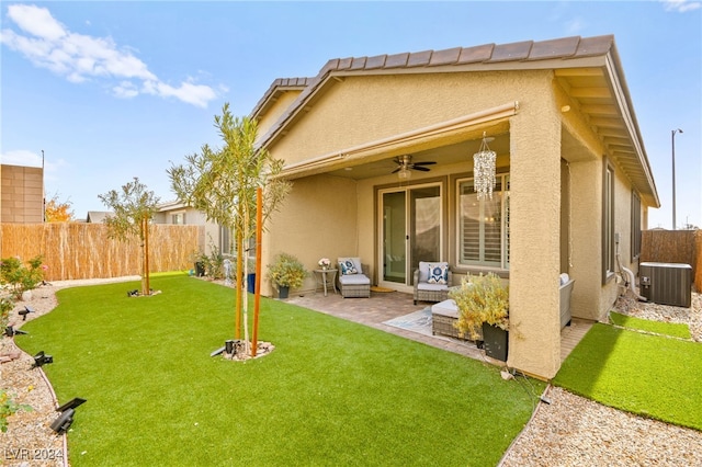 rear view of house with a lawn, ceiling fan, a patio area, and central AC