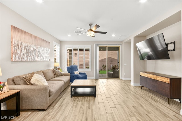 living room with ceiling fan and light hardwood / wood-style floors