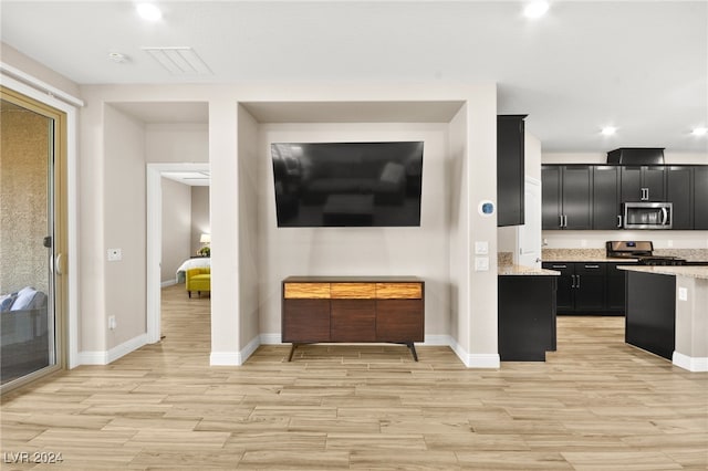 kitchen featuring light stone counters and stainless steel appliances