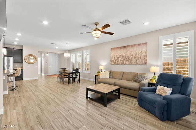 living room featuring ceiling fan and light hardwood / wood-style floors