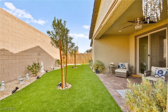 view of yard with a patio area and ceiling fan