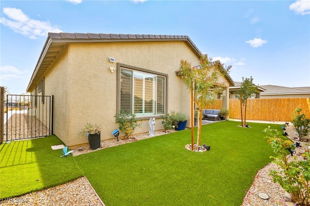 exterior space with a yard, a patio, and an outdoor hangout area