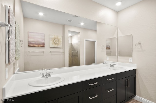 bathroom featuring a shower and vanity