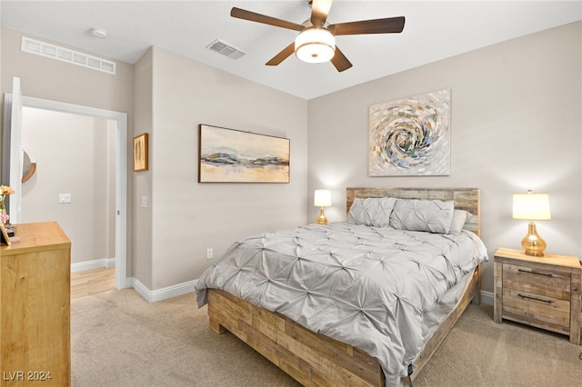 bedroom with ceiling fan and light carpet