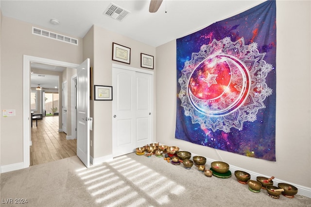 game room featuring ceiling fan and light colored carpet