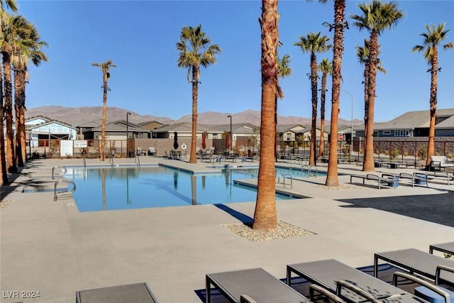 view of swimming pool featuring a mountain view and a patio area