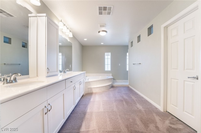 bathroom with vanity and a tub