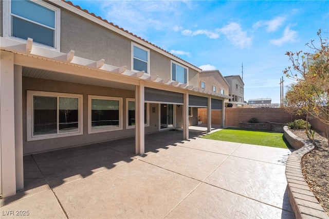 rear view of house with a patio area and a yard