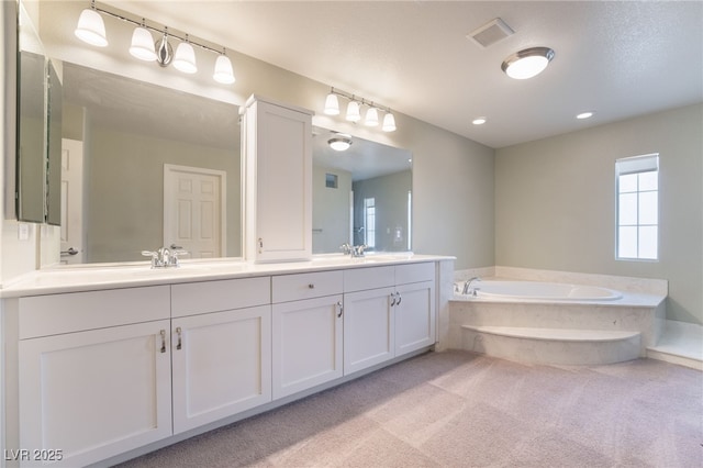 bathroom featuring vanity and a bath